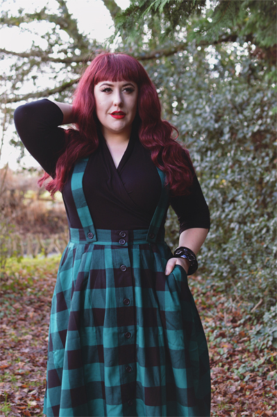 Plus size pinup Miss Amy May models the Green Teen Spirit Pinafore skirt gifted by Hell Bunny for a fit and sizing review