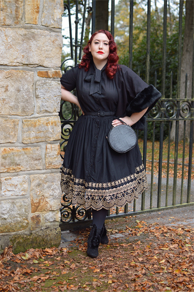 Plus size pinup Miss Amy May models the Black and Gold Eyelet Border Cora dress by Unique Vintage for a fit and sizing review