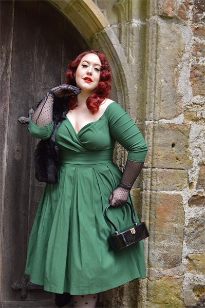 Plus size pinup Miss Amy May models the green Marceline dress by Unique Vintage for a fit and sizing review