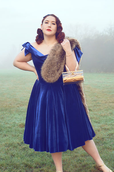 Plus size pinup Miss Amy May models the Sapphire Velvet Tilly Bow Prom swing dress by The Pretty Dress Company for a fit and size review