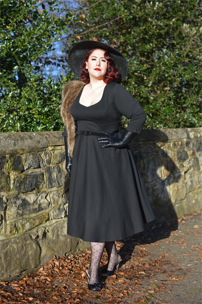 Plus size pinup Miss Amy May models the black Scarlette dress by Dolly & Dotty for a fit and sizing review